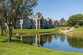 Overland Park apartment for rent - A welcoming apartment building at Hawthorne Apartment Homes with a brick facade and green surroundings